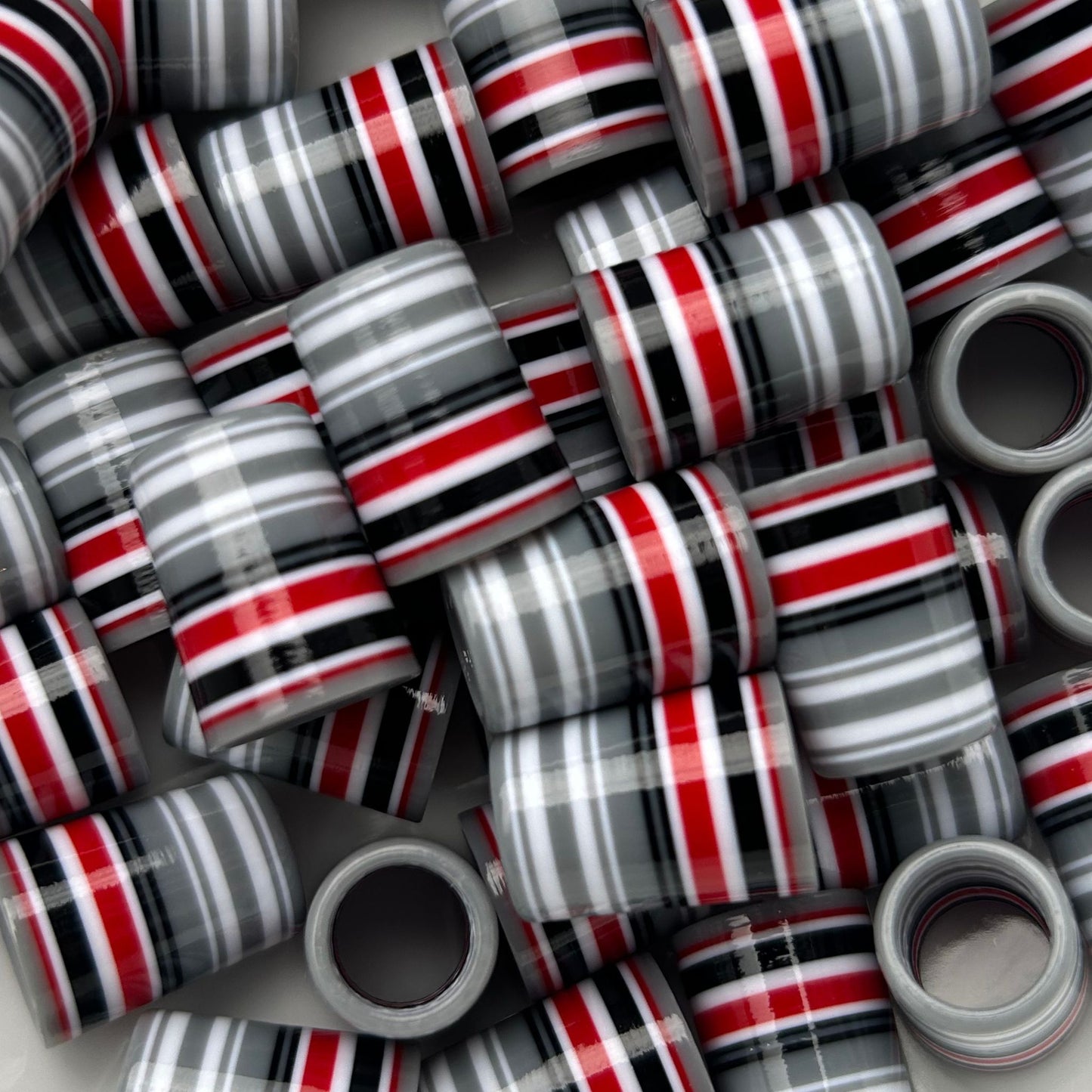 gray, white, black, and red golf ferrules
