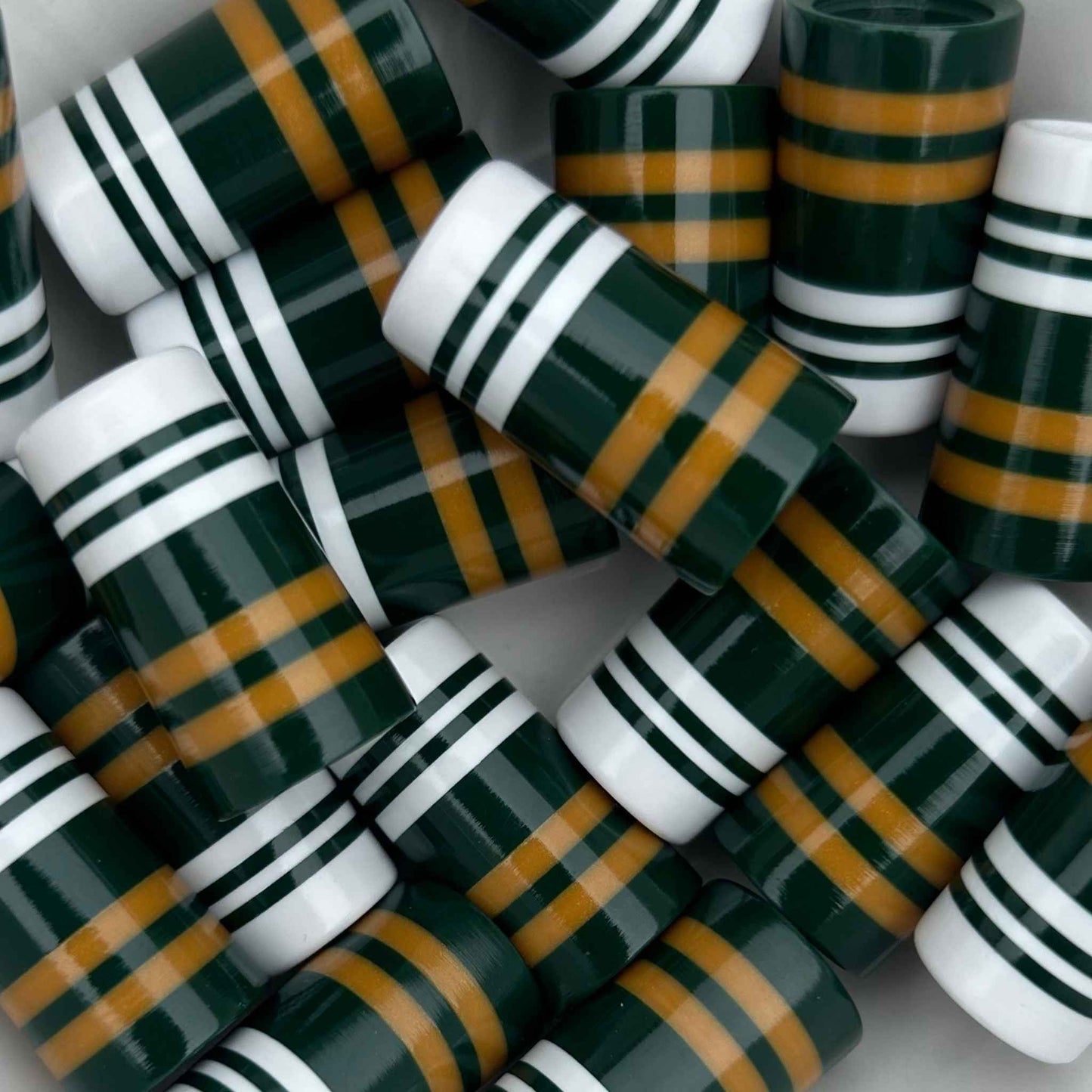 green, white, and golden yellow striped golf ferrules, 3D-printed with precision.