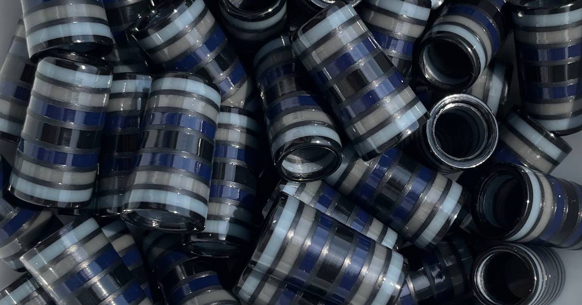 pile of black, gray, and blue striped golf ferrules