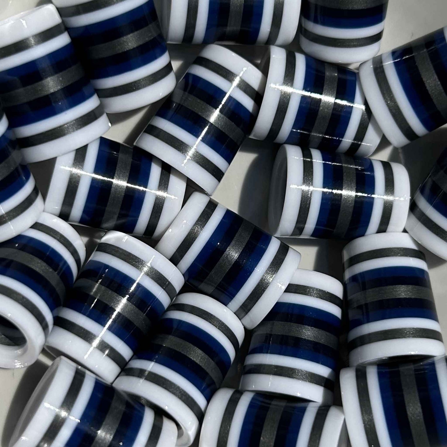White golf ferrules with navy, black, and silver stripes.