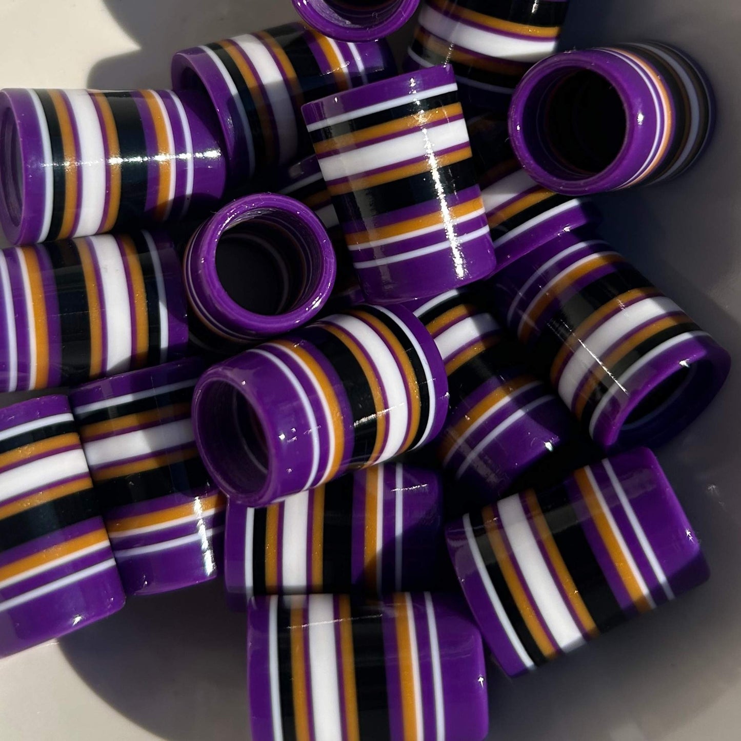 purple golf ferrules with black, white, and gold stripes
