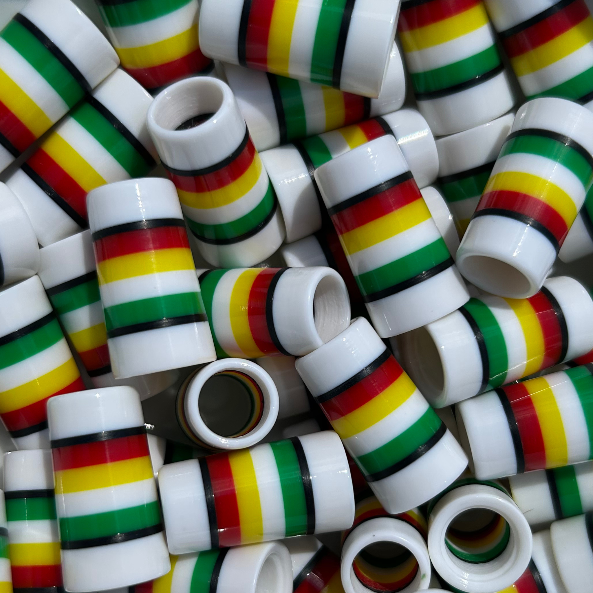 white golf ferrules with black, red, yellow, and green stripes