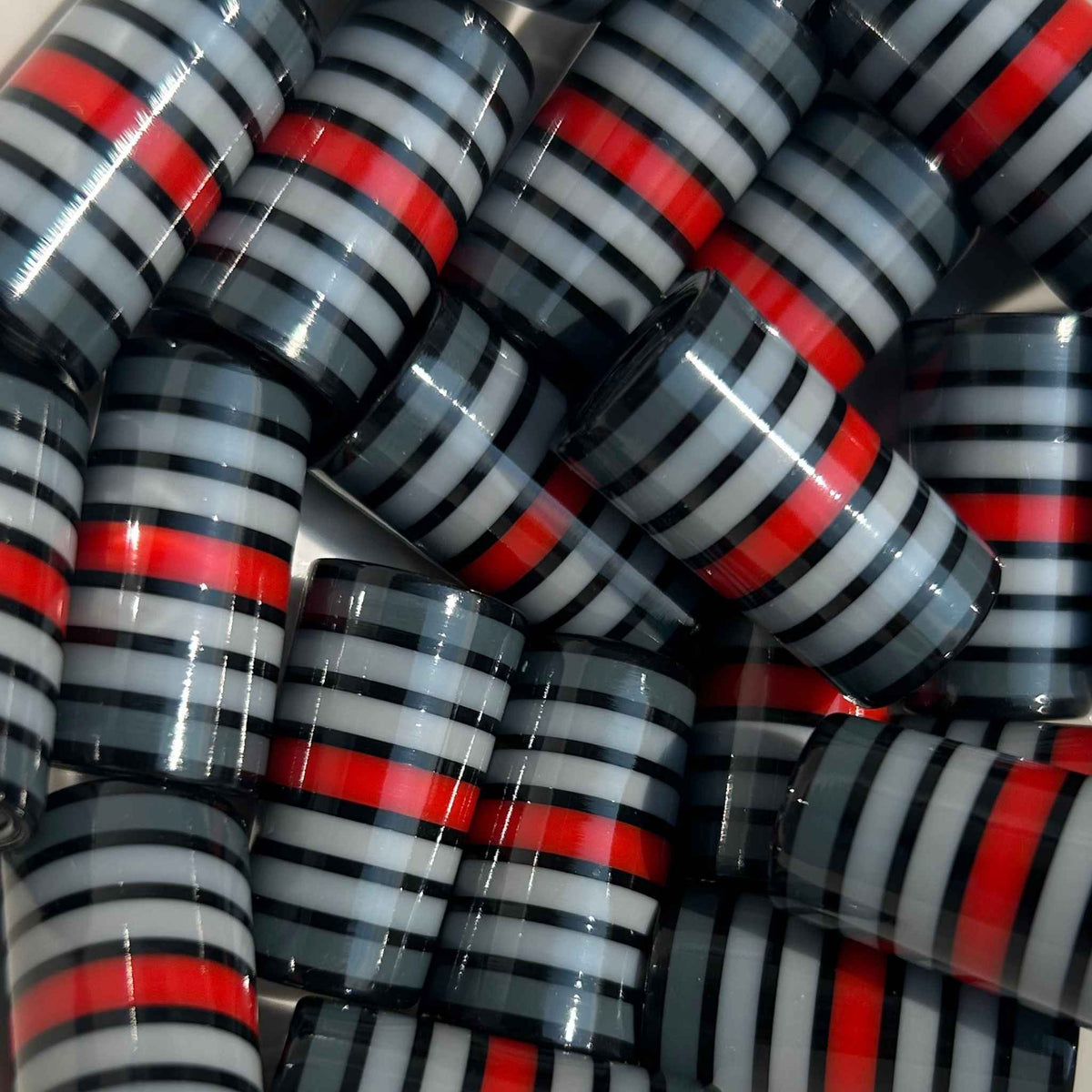 black, gray, and red golf ferrules, 3D-printed with uniform stripe pattern.
