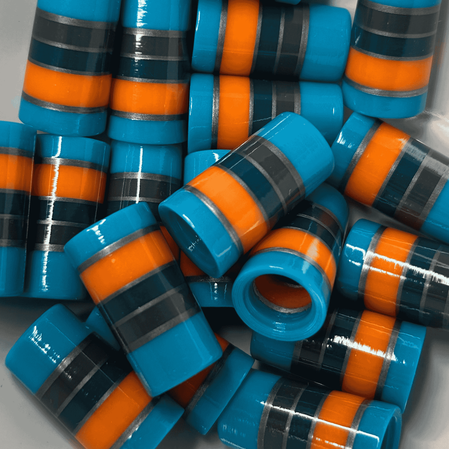 custom golf ferrules in teal, green, silver, orange, and gray