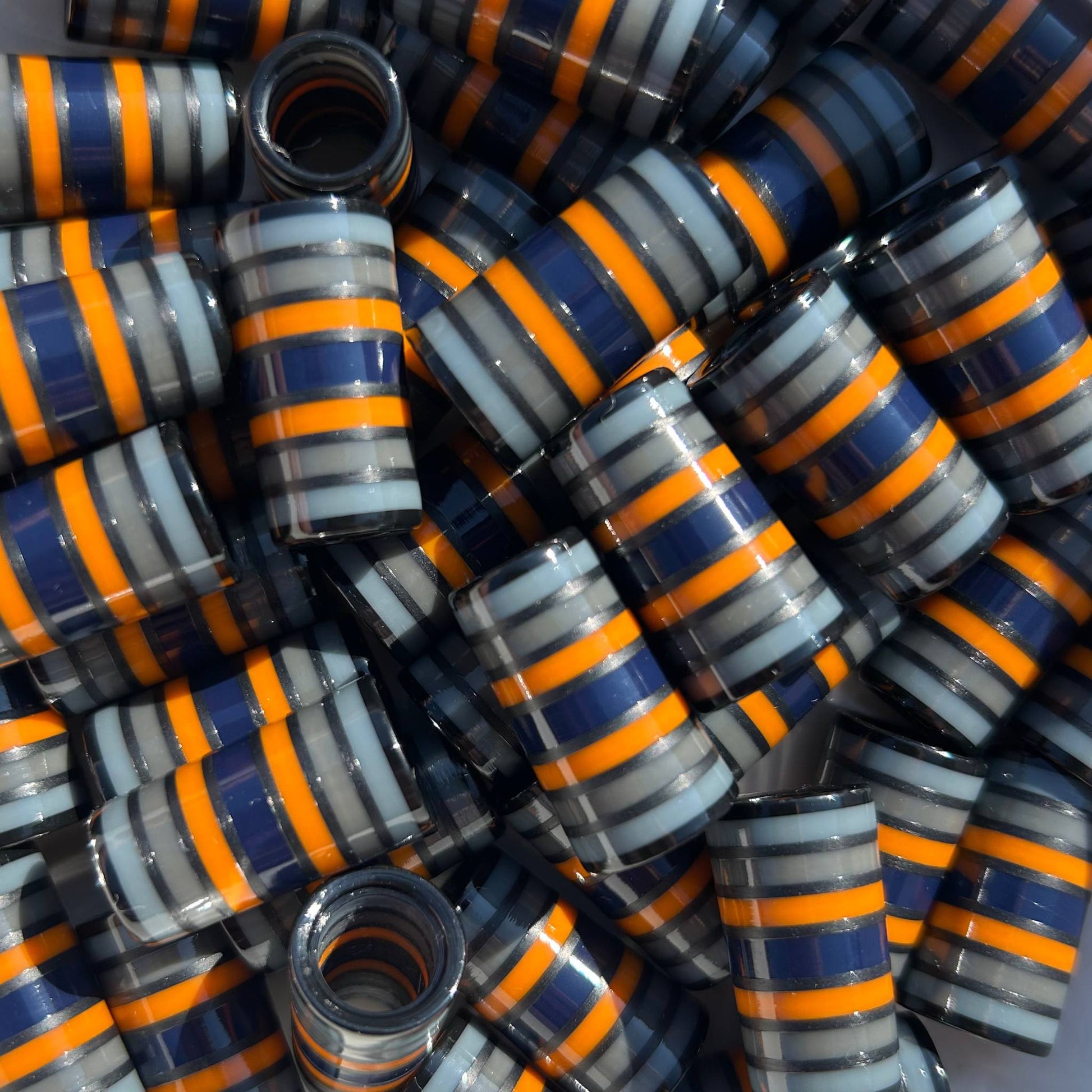 Stack of gray, orange, and navy blue golf ferrules