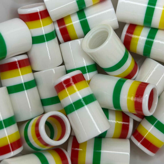 pile of 1" white golf ferrules with green, white, yellow, and red stripes at the top