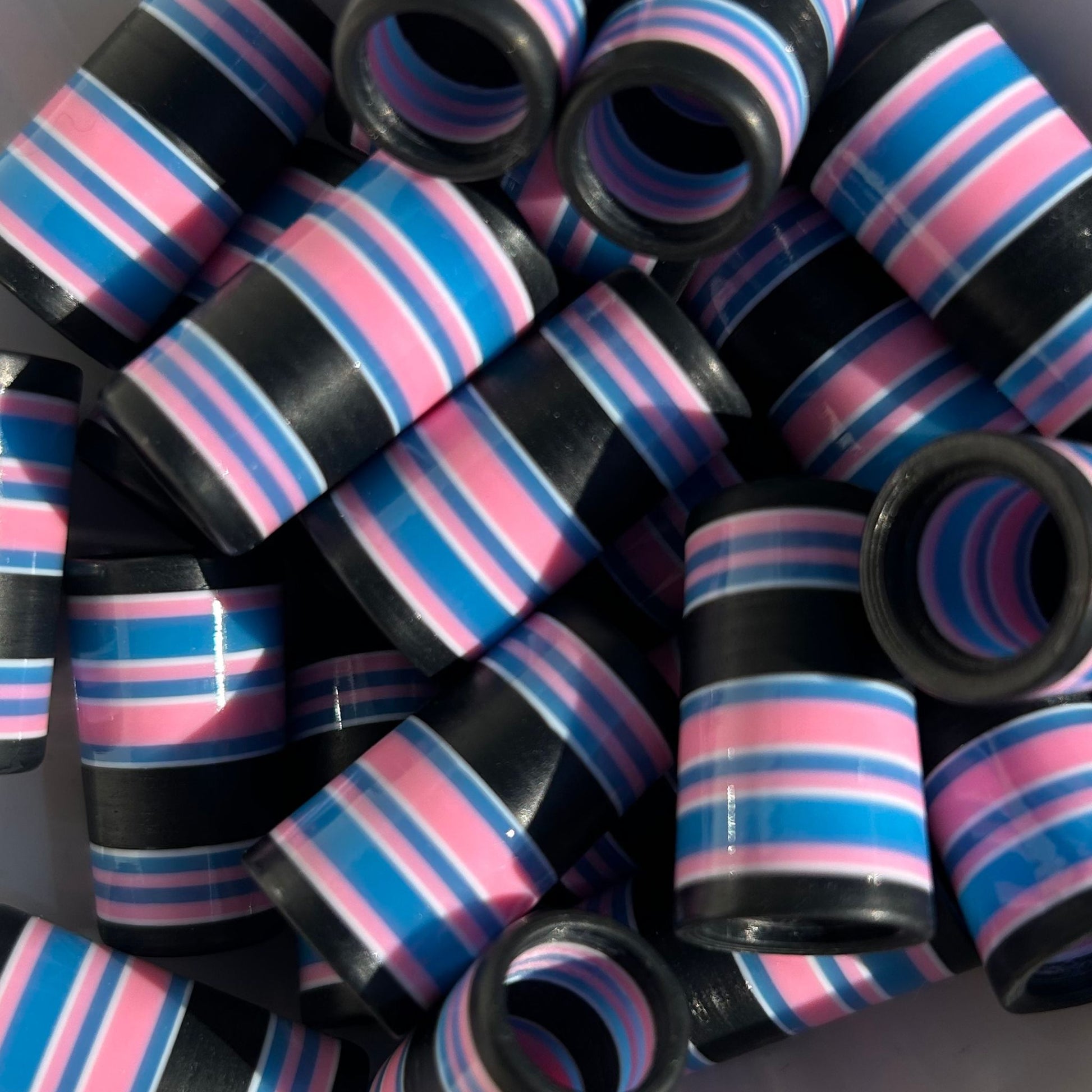 close-up of black, blue, pink, and white golf ferrules