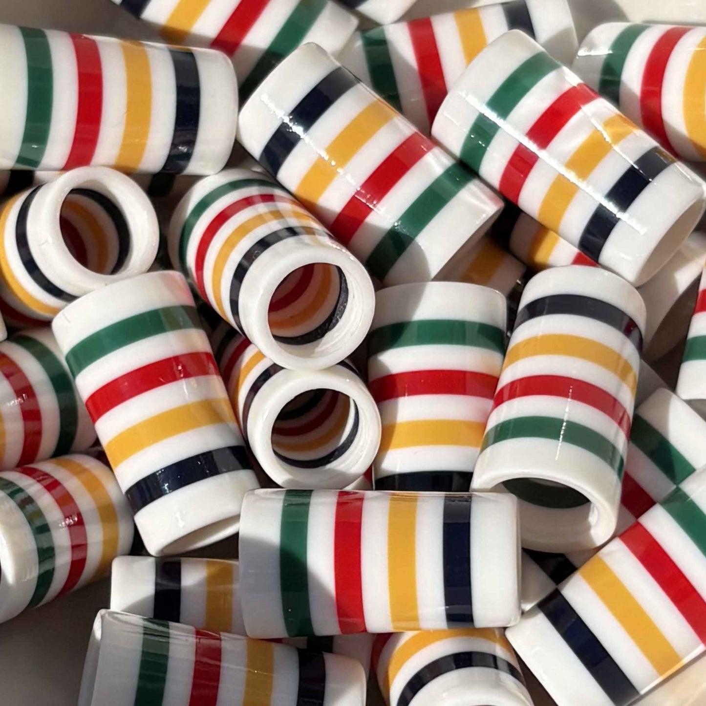 white golf ferrules with colored stripes in navy, yellow, red, and green