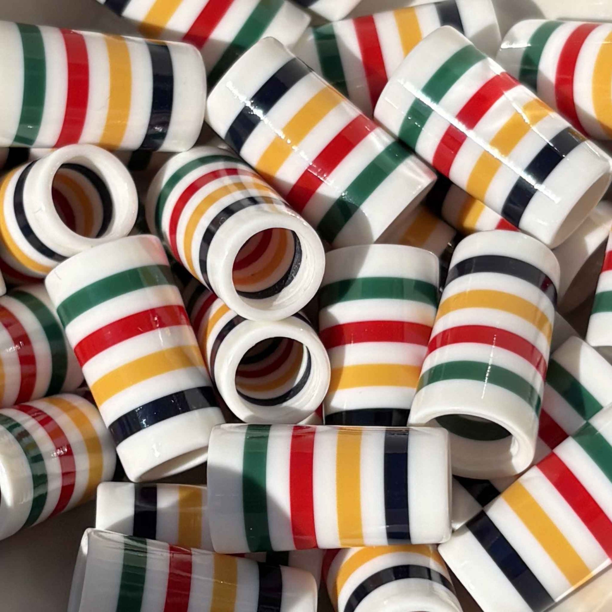 white golf ferrules with colored stripes in navy, yellow, red, and green