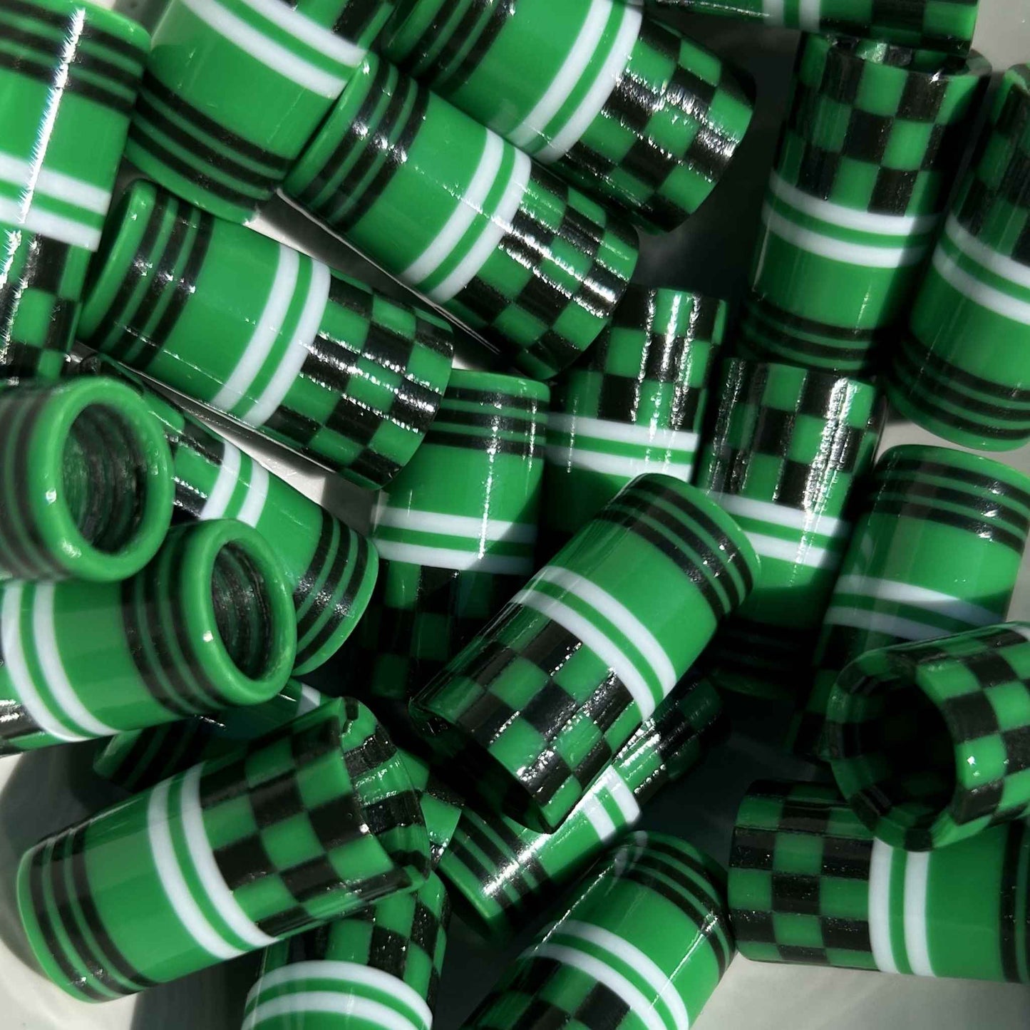 green, black, and white 3D-printed golf ferrules in a checkered pattern