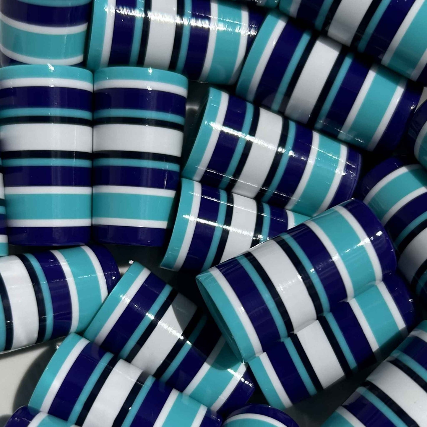 Teal and purple golf ferrules with many stripes.