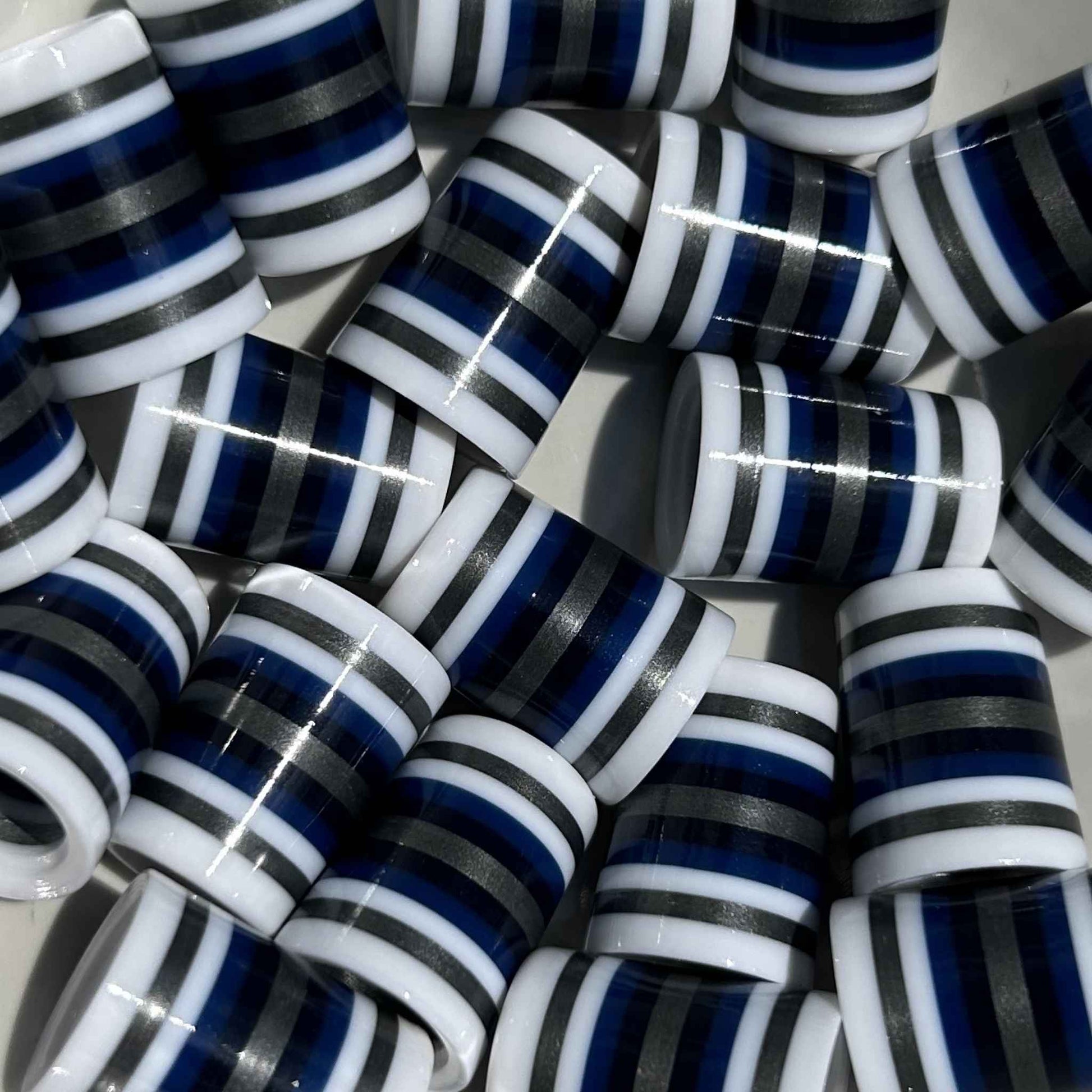 White golf ferrules with navy, black, and silver stripes.