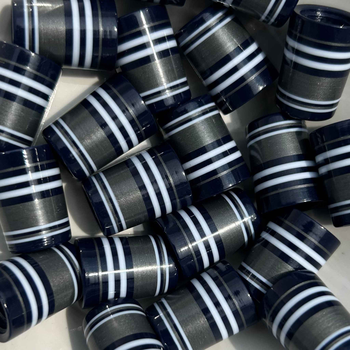 Navy blue, silver, and white golf ferrules, 3D-printed.