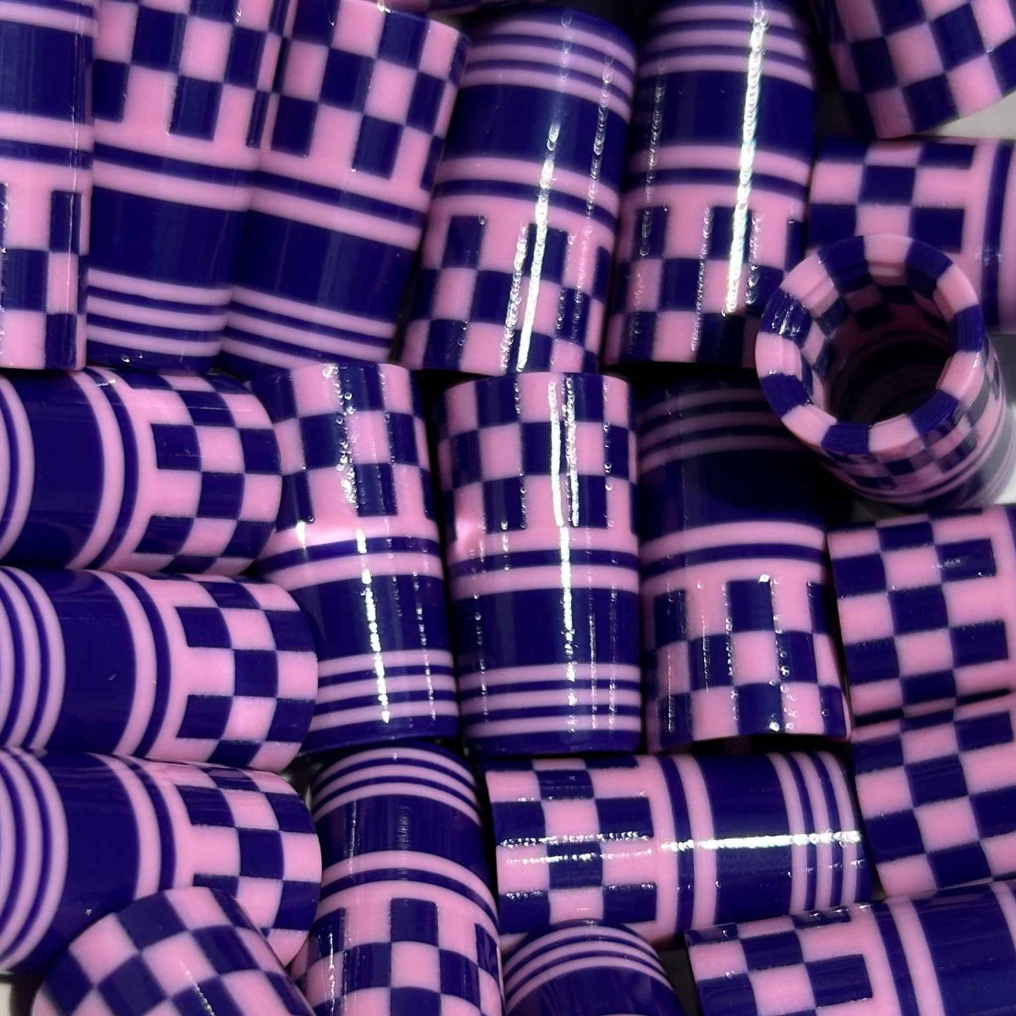 Purple and pink checkered and striped 3D-printed golf ferrules.