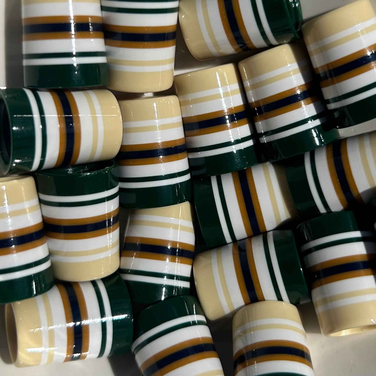 Beige, white, and forest green golf ferrules with gold accents.