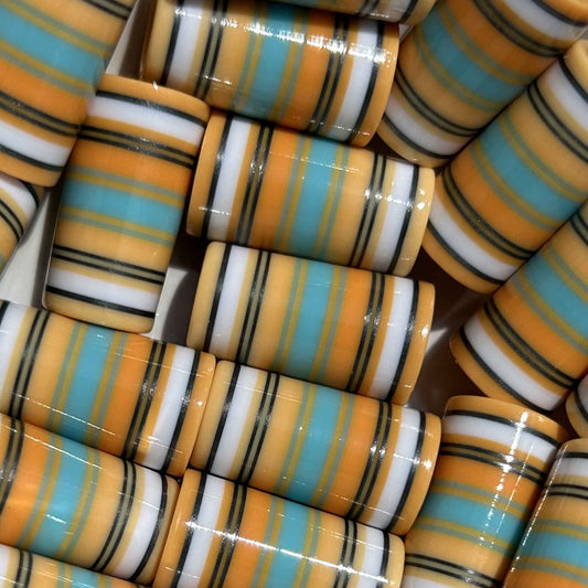 Orange cream golf ferrules with teal, white, and black accent stripes.