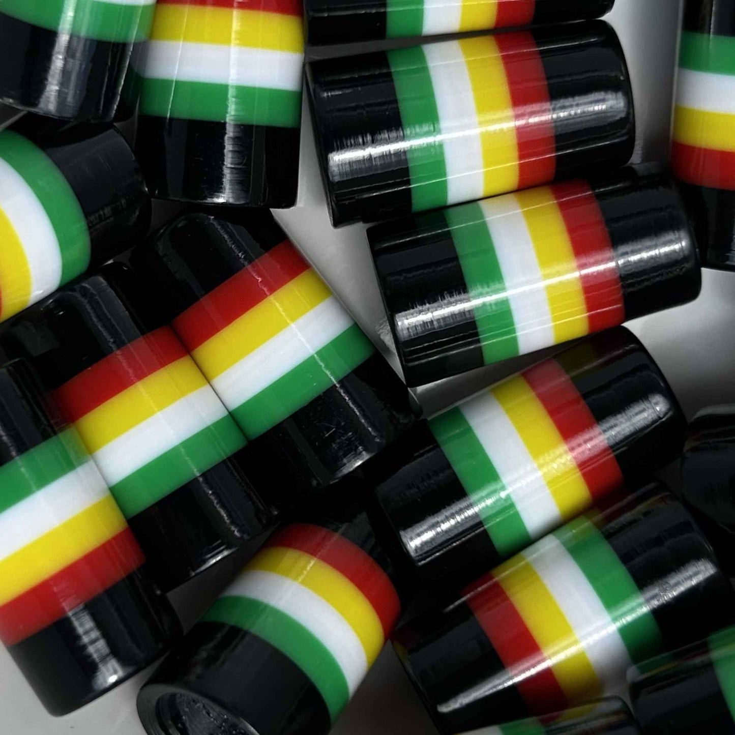Black, red, yellow, white, and green striped golf ferrules.