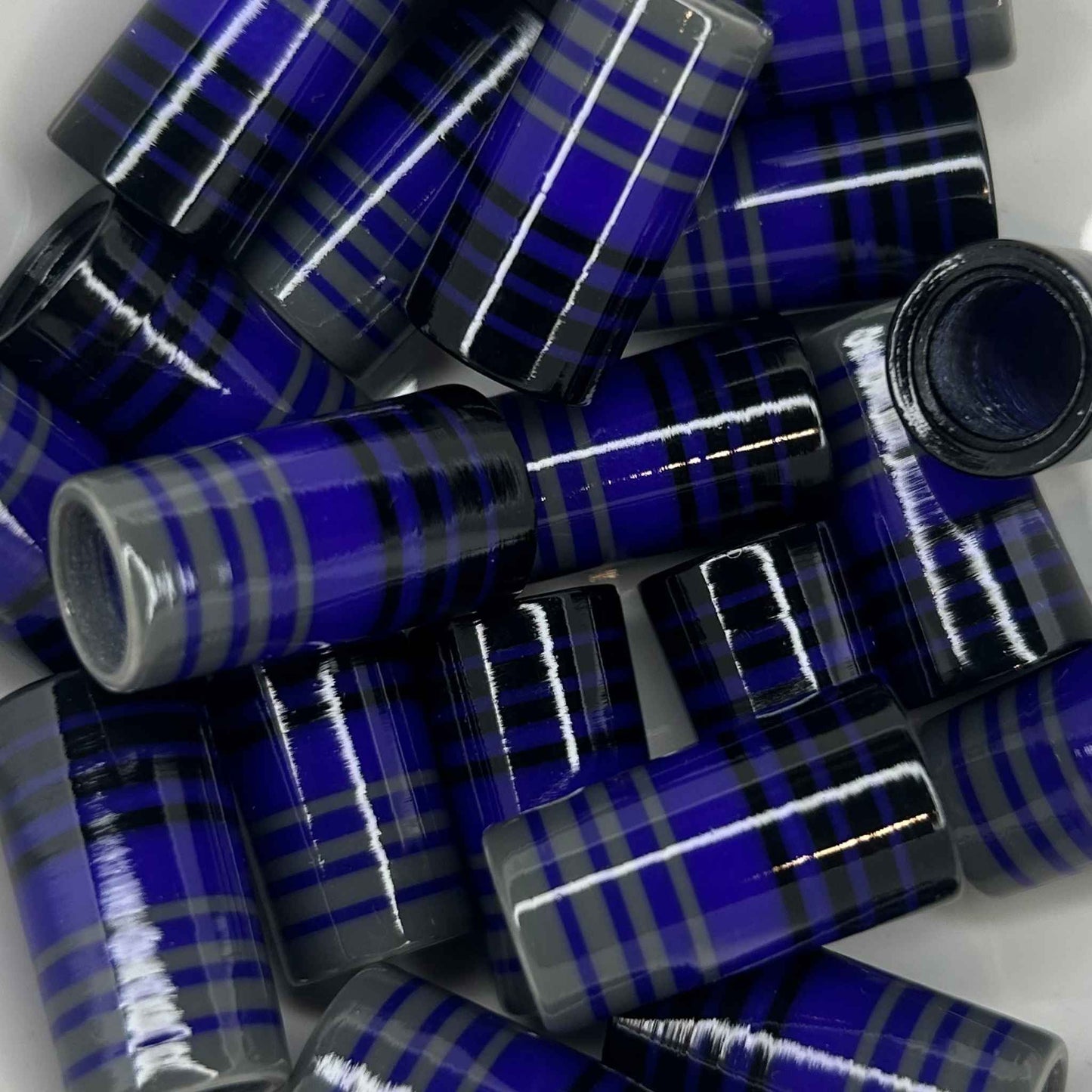 pile of black, purple, and gray golf ferrules