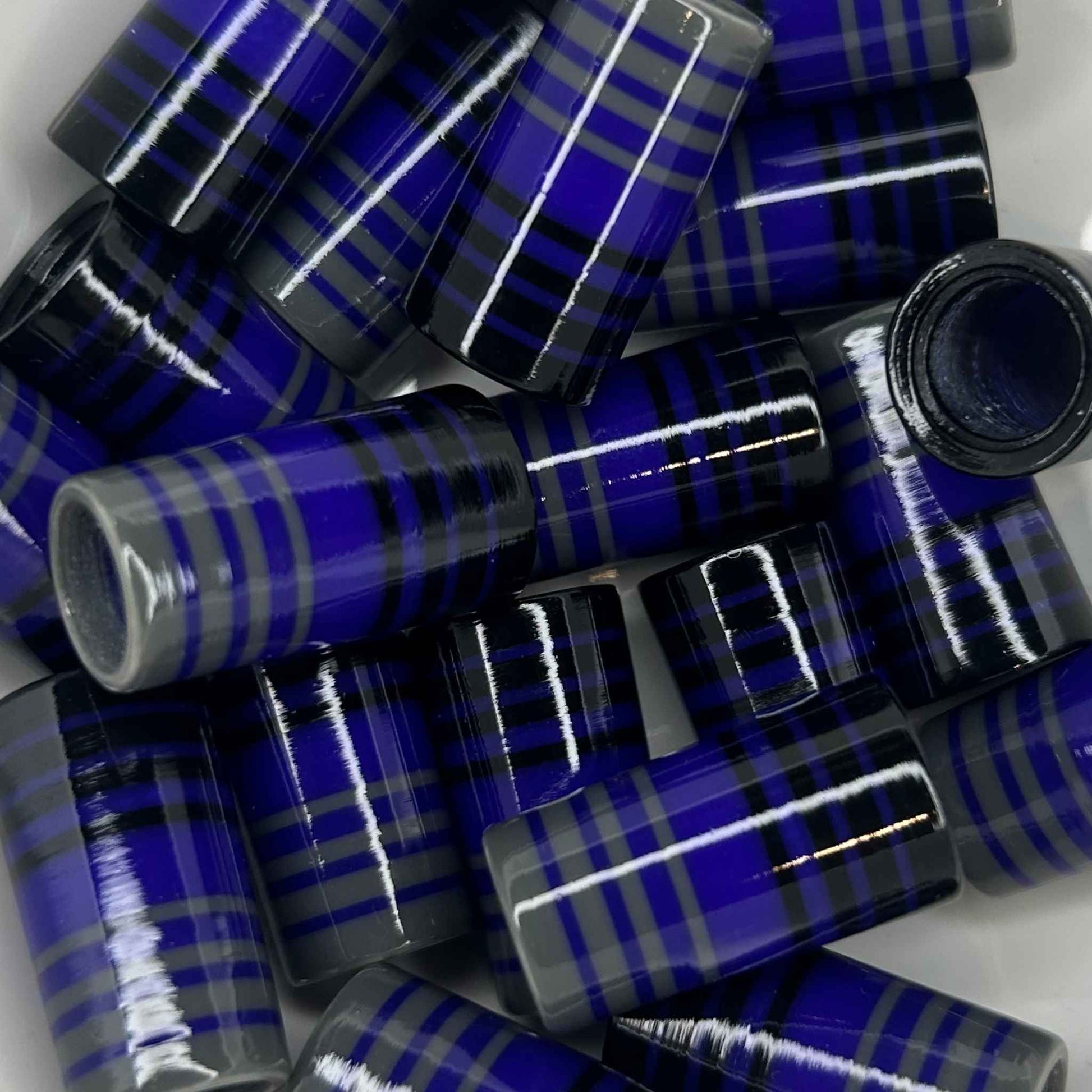 pile of black, purple, and gray golf ferrules