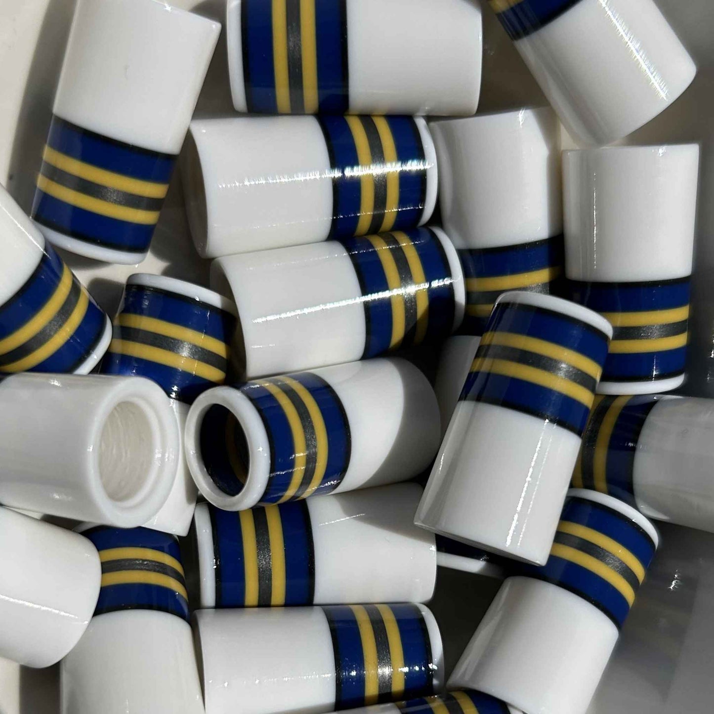 white golf ferrules with blue, yellow, and silver stripes at the top