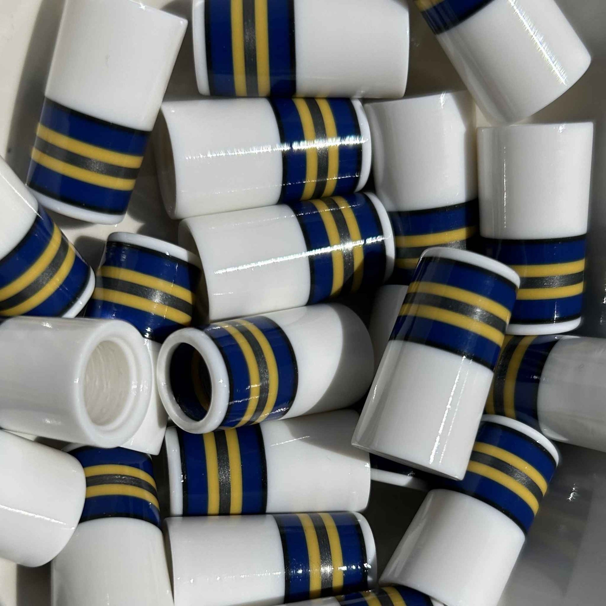 white golf ferrules with blue, yellow, and silver stripes at the top