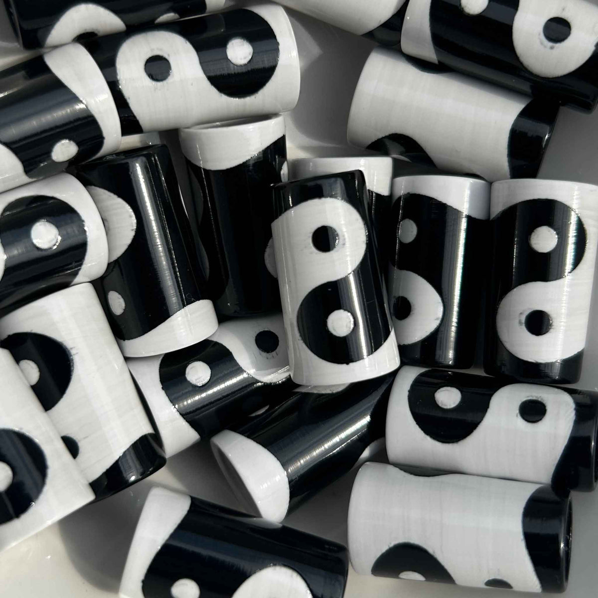 A pile of black and white Yinyang patterned golf ferrules.