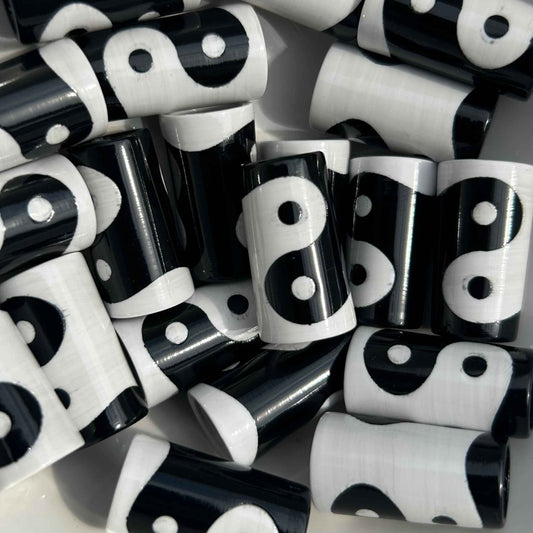 A pile of black and white Yinyang patterned golf ferrules.